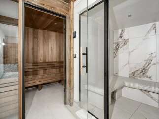Experience ultimate relaxation in this luxurious spa area, featuring a traditional wooden sauna and a modern steam room.
