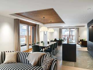 Experience luxury living in this modern open-plan apartment, featuring a spacious dining area with a sleek table and plush seating, perfect for entertaining.