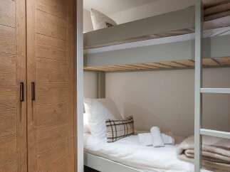 This cozy bedroom features a space-saving bunk bed, perfect for families or guests.