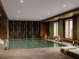 Experience ultimate relaxation in this luxurious indoor swimming pool area, featuring a stunning mosaic-tiled pool and floor-to-ceiling wooden paneling.