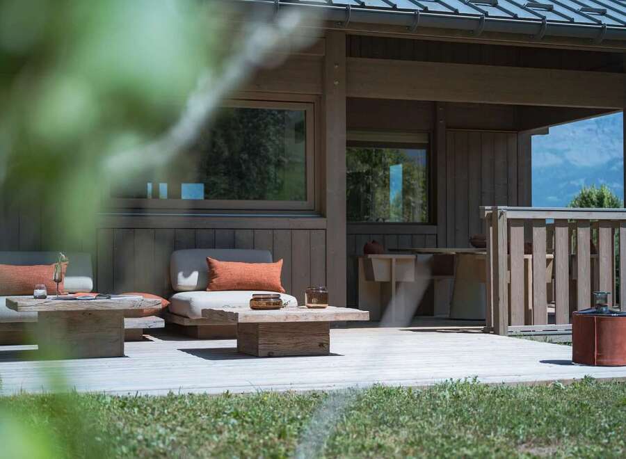 Experience modern living with this stunning property featuring a spacious wooden deck, perfect for outdoor entertaining.