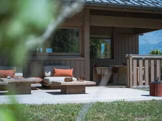 Experience modern living with this stunning property featuring a spacious wooden deck, perfect for outdoor entertaining.