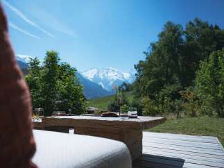 Enjoy breathtaking mountain views from this stunning outdoor seating area.