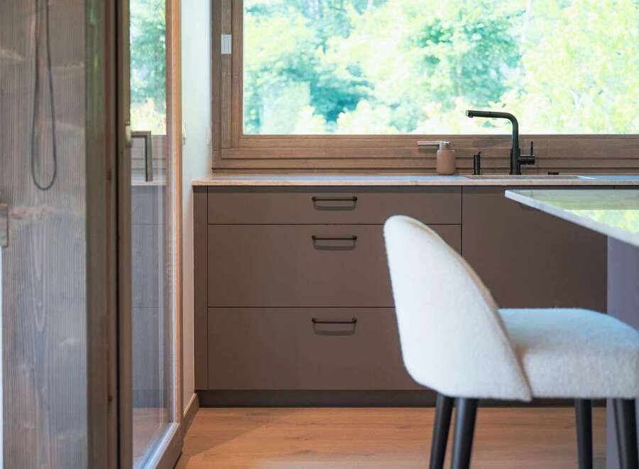 Experience modern living in this beautifully designed kitchen, featuring sleek, dark cabinetry and a spacious countertop.