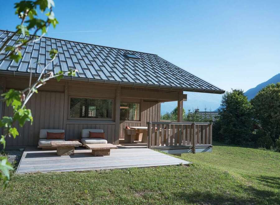 Experience serene mountain living in this charming wooden cabin, featuring a spacious deck perfect for enjoying the breathtaking alpine views.