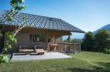 Experience serene mountain living in this charming wooden cabin, featuring a spacious deck perfect for enjoying the breathtaking alpine views.