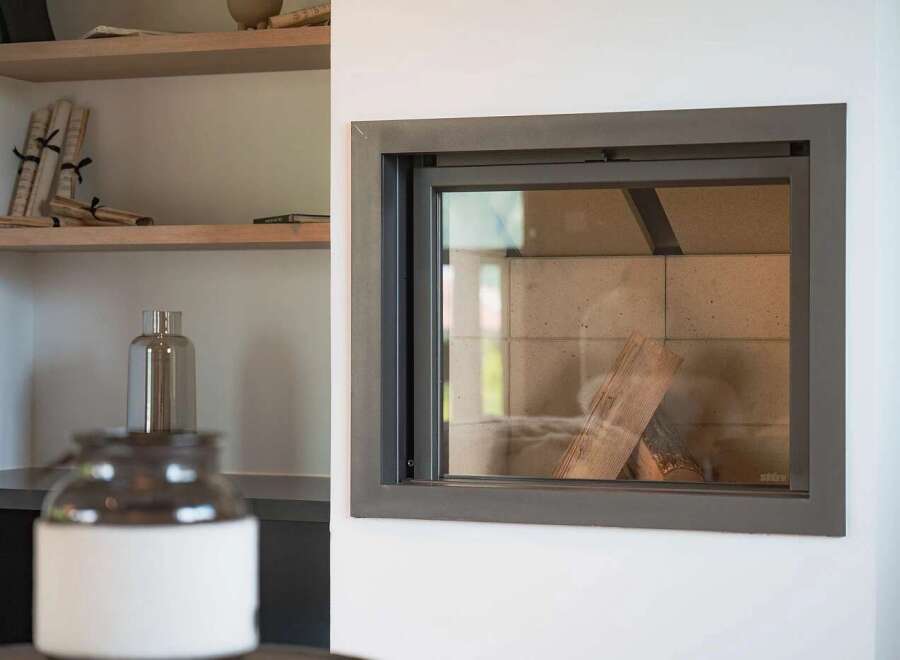 Experience modern living with this sleek fireplace, featuring a clean-lined design and a glass front that offers a view of the logs within.