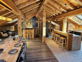 Experience luxury living in this stunning attic apartment, featuring a spacious open-plan living area with a modern kitchen and dining space.