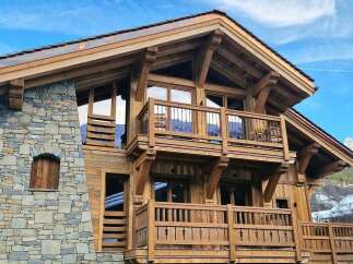 Experience luxury mountain living in this stunning chalet, featuring a robust stone and timber construction.