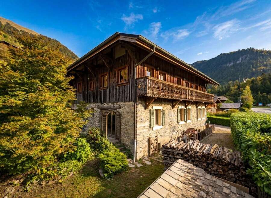 Experience the charm of this traditional alpine chalet, featuring rustic wooden architecture and a stone base, perfect for a cozy mountain getaway.