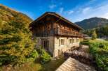 Experience the charm of this traditional alpine chalet, featuring rustic wooden architecture and a stone base, perfect for a cozy mountain getaway.
