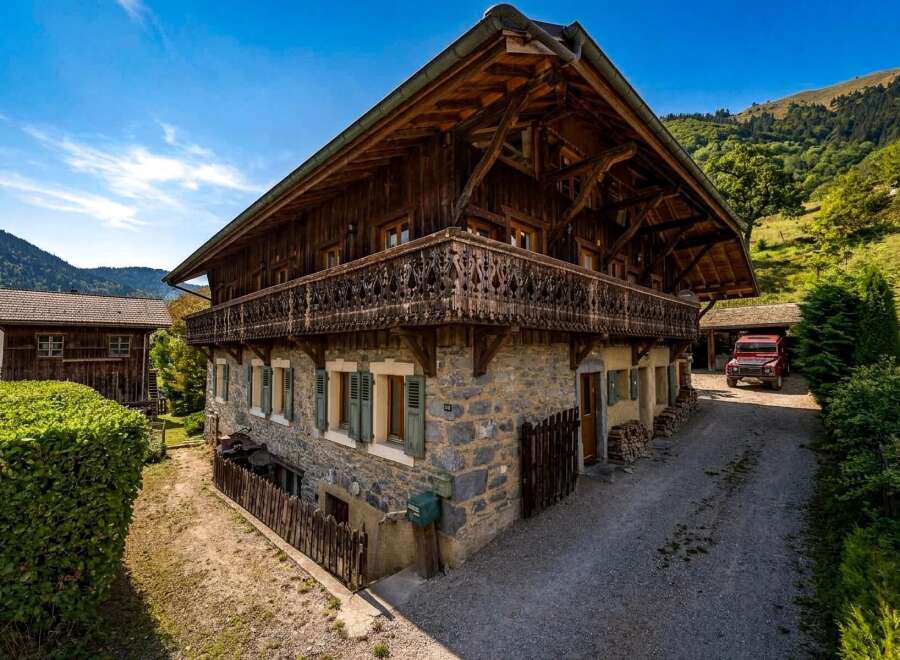 Experience the charm of this traditional wooden chalet nestled in a picturesque mountain landscape.