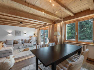 Experience rustic charm and modern comfort in this inviting living and dining area.