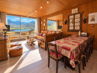 Experience breathtaking mountain and lake views from this charming wooden chalet living room.