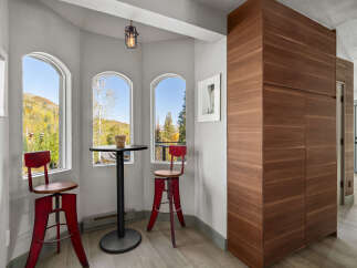 Enjoy breathtaking mountain views from this charming breakfast nook, featuring two arched windows that flood the space with natural light.