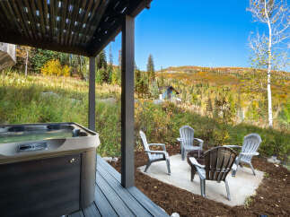 Enjoy the stunning mountain views from this luxurious hot tub, perfect for relaxing after a day of outdoor adventures.