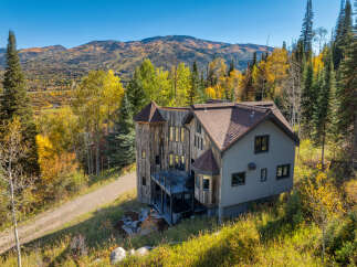 Experience mountain living in this stunning home, nestled amidst vibrant autumn foliage and offering breathtaking panoramic views.