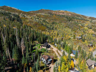 Nestled amidst a vibrant autumn forest, this property offers a serene mountain retreat.