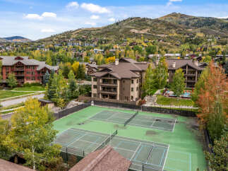 Experience luxury mountain living with this stunning property featuring multiple tennis courts and a sparkling swimming pool, perfect for active recreation.