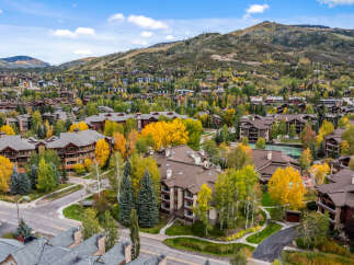 Experience luxury mountain living in this stunning property nestled amidst vibrant autumn foliage.
