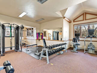 This home gym offers a comprehensive workout experience with a variety of equipment.