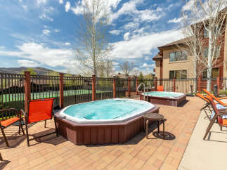 Enjoy ultimate relaxation in this stunning outdoor oasis, featuring two luxurious hot tubs perfect for unwinding.