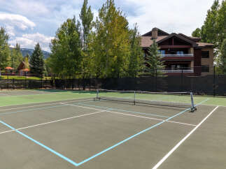 Enjoy outdoor recreation on this pristine tennis court, perfect for a friendly match or practice.