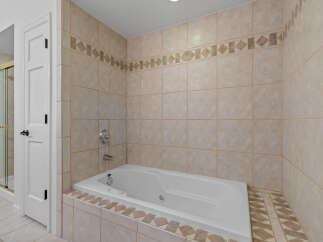 Indulge in relaxation with this luxurious jetted bathtub, perfect for unwinding after a long day.