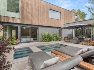 Experience modern luxury in this stunning backyard oasis, featuring a sleek plunge pool and spa perfect for relaxation.
