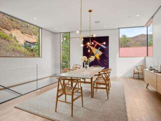 Experience breathtaking mountain views from this stunning dining room, featuring expansive windows that frame the natural landscape.