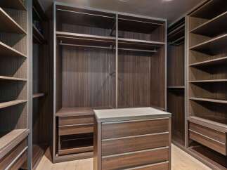 Step into this luxurious walk-in closet, meticulously designed for the discerning homeowner.