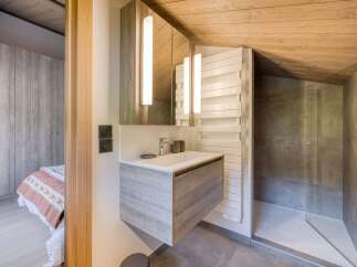 Experience modern comfort in this beautifully appointed bathroom, featuring a sleek vanity with ample storage and a minimalist sink.