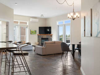 Step into this inviting living space featuring a cozy fireplace and a large television, perfect for relaxing evenings.