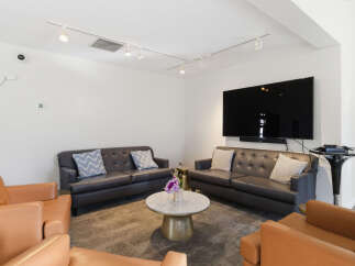 This inviting living space features comfortable seating arrangements, including plush sofas and accent chairs, perfect for relaxation and entertaining.