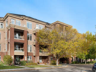 Discover modern living in this stunning condo building, featuring a beautiful brick and stucco exterior.