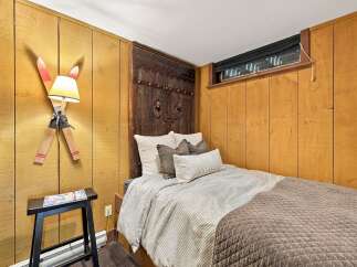 This cozy bedroom features a unique headboard resembling an antique wooden door, adding a rustic charm.