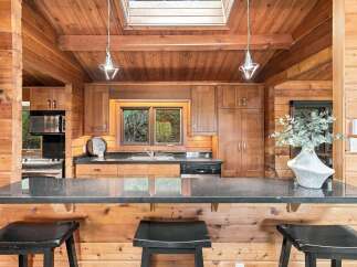 Experience rustic charm in this beautifully appointed log cabin kitchen.