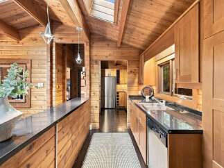 Experience rustic charm in this beautifully appointed log cabin kitchen.