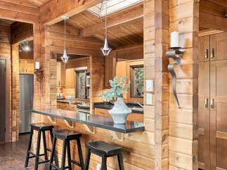 Experience rustic charm in this beautifully appointed log cabin kitchen.