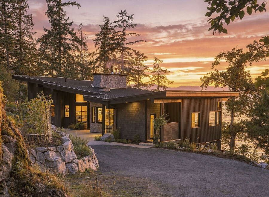 Experience modern luxury in this stunning contemporary home, nestled amidst lush trees with breathtaking ocean views.