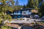Experience modern luxury with this stunning waterfront home, featuring expansive windows that capture breathtaking ocean views.