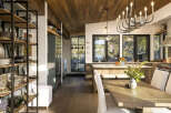 Experience modern rustic charm in this stunning kitchen and dining area, featuring a warm wood-paneled ceiling and expansive windows that flood the space with natural light.
