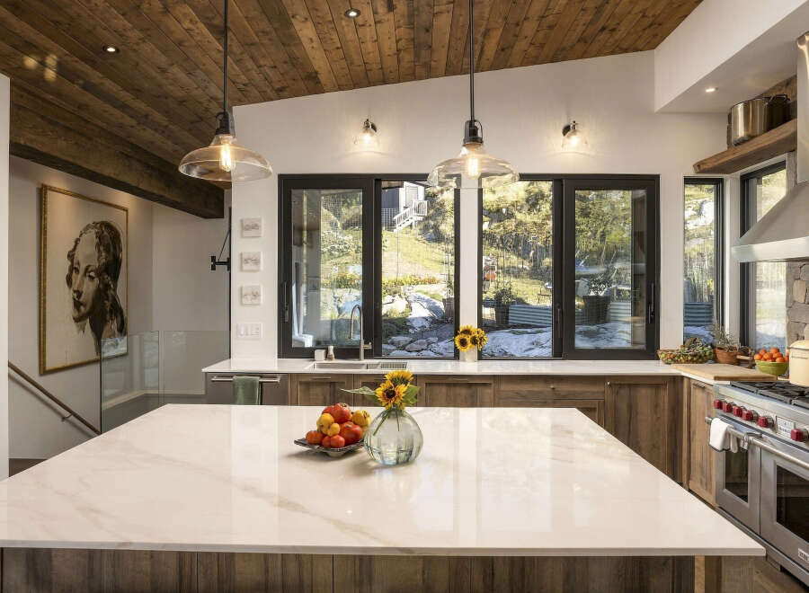 Experience luxury mountain living in this stunning kitchen, featuring a spacious marble island perfect for entertaining.