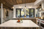 Experience luxury mountain living in this stunning kitchen, featuring a spacious marble island perfect for entertaining.