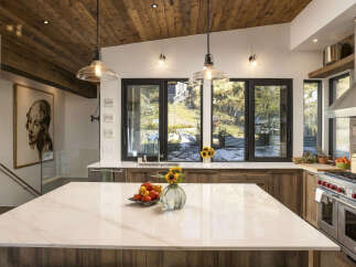Experience luxury mountain living in this stunning kitchen, featuring a spacious marble island perfect for entertaining.