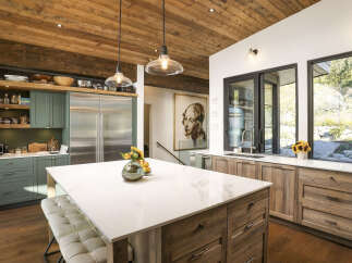 Experience luxury in this stunning modern kitchen, featuring a spacious island with a marble countertop and comfortable seating.