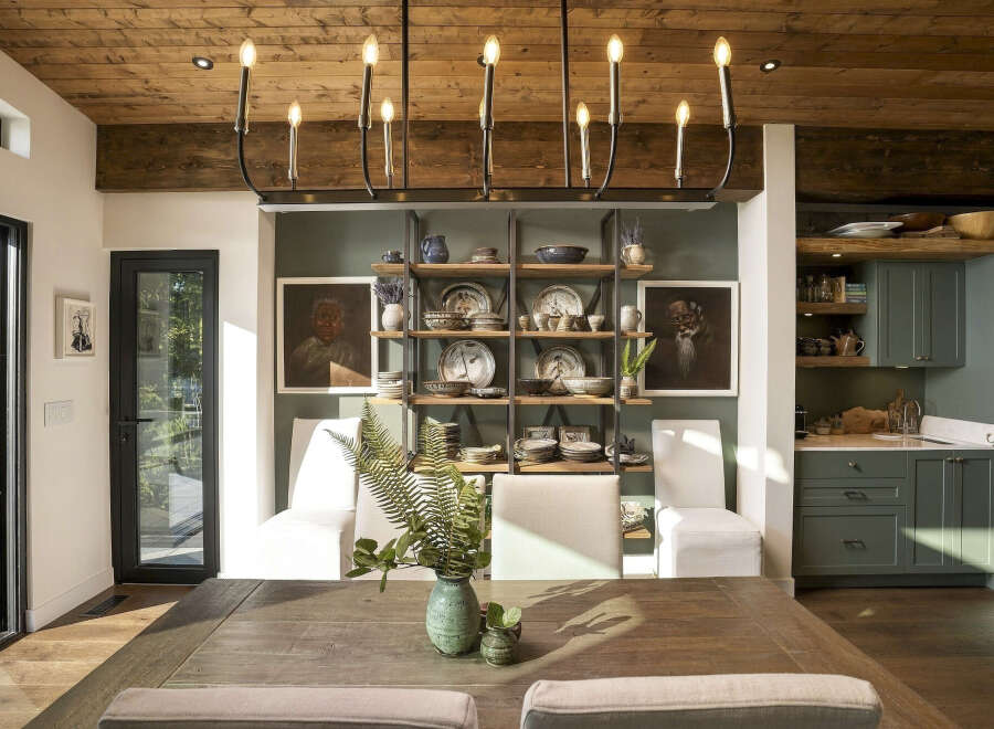 Experience rustic charm and modern elegance in this dining area, featuring a warm wooden ceiling and exposed beams.