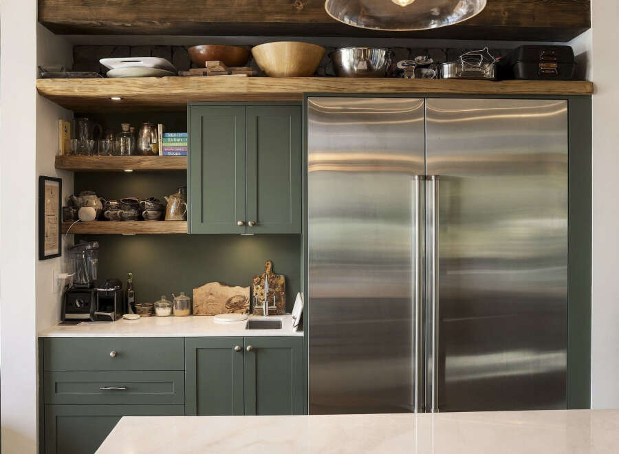 Discover a chef's dream kitchen featuring a spacious stainless steel refrigerator and ample cabinet space for all your culinary needs.