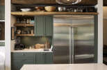 Discover a chef's dream kitchen featuring a spacious stainless steel refrigerator and ample cabinet space for all your culinary needs.