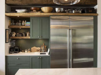 Discover a chef's dream kitchen featuring a spacious stainless steel refrigerator and ample cabinet space for all your culinary needs.